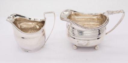 A George III plain silver helmet shaped cream jug, reeded border, hallmarked London, 1800, maker's
