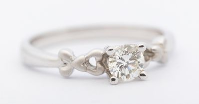 A diamond and 18ct white gold solitaire ring, comprising a claw set round brilliant cut diamond