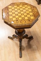 A Victorian vari-wood octagonal sewing / games table, the marquetry cover opens to reveal eleven