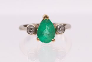 An emerald and diamond 18ct gold ring, comprising a pear cut emerald, measuring approx 1.86 carat,