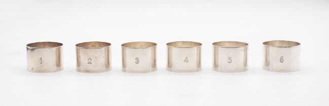 A set of six George V plain silver napkin rings, numbered 1 to 6, hallmarked by Docker & Burn,