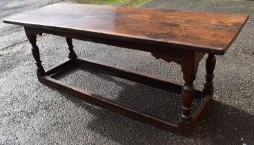 An English oak 17th Century Refectory table, rectangular plank cleated top with carved and