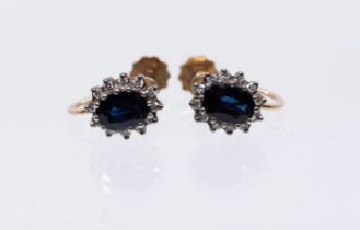 A pair of sapphire and diamond 9ct gold cluster earrings, comprising a central oval mixed cut