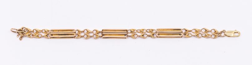 A fancy link double row 15ct gold bracelet, comprising lozenge shaped links with spring like