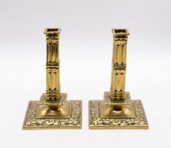 A pair of North European probably Dutch brass candlesticks, circa 1660, square cluster columns above