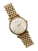 Garrard- a gentleman's 9ct gold vintage wristwatch, comprising a round silvered signed dial with