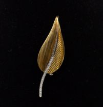 A diamond and 18ct two tone brooch, by Picchiotti, comprising a leaf like form in yellow gold,