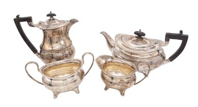 A George V matched silver four piece tea service to include: teapot, hot water jug, sugar bowl and