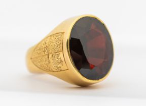 An early 20th century garnet and 18ct gold ring, comprising an oval mixed cut garnet, approx 13 x