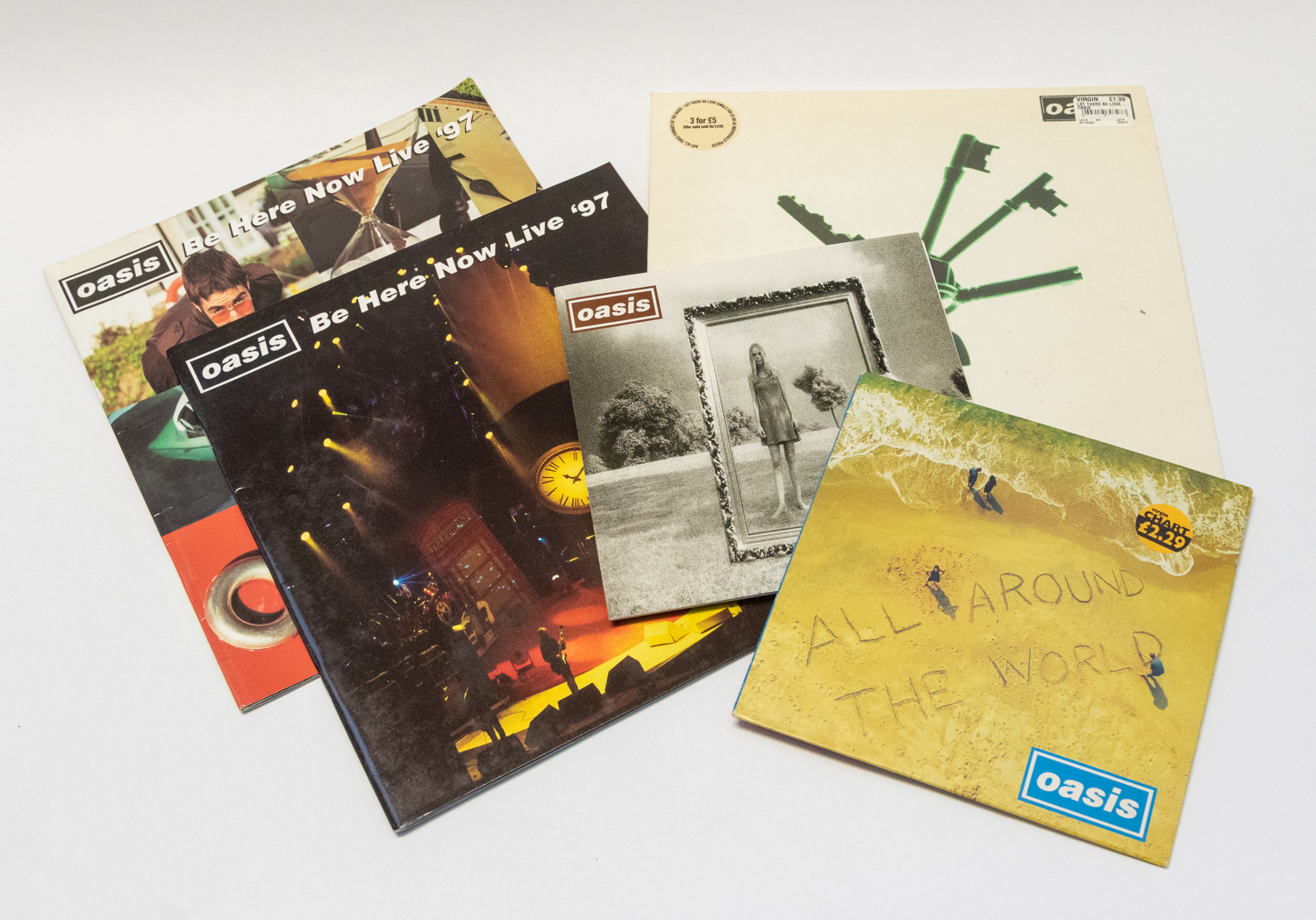 Oasis - small collection including 2 x 1997 Tour Programmes, 7 inch All around the world - 7 inch