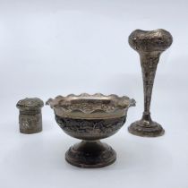 An Indian white metal pedestal bowl, having undulating rim, the side repousse mounted hunter with