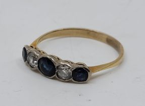 A yellow metal, sapphire and diamond ring, set three graduated mixed cut sapphires alternating two