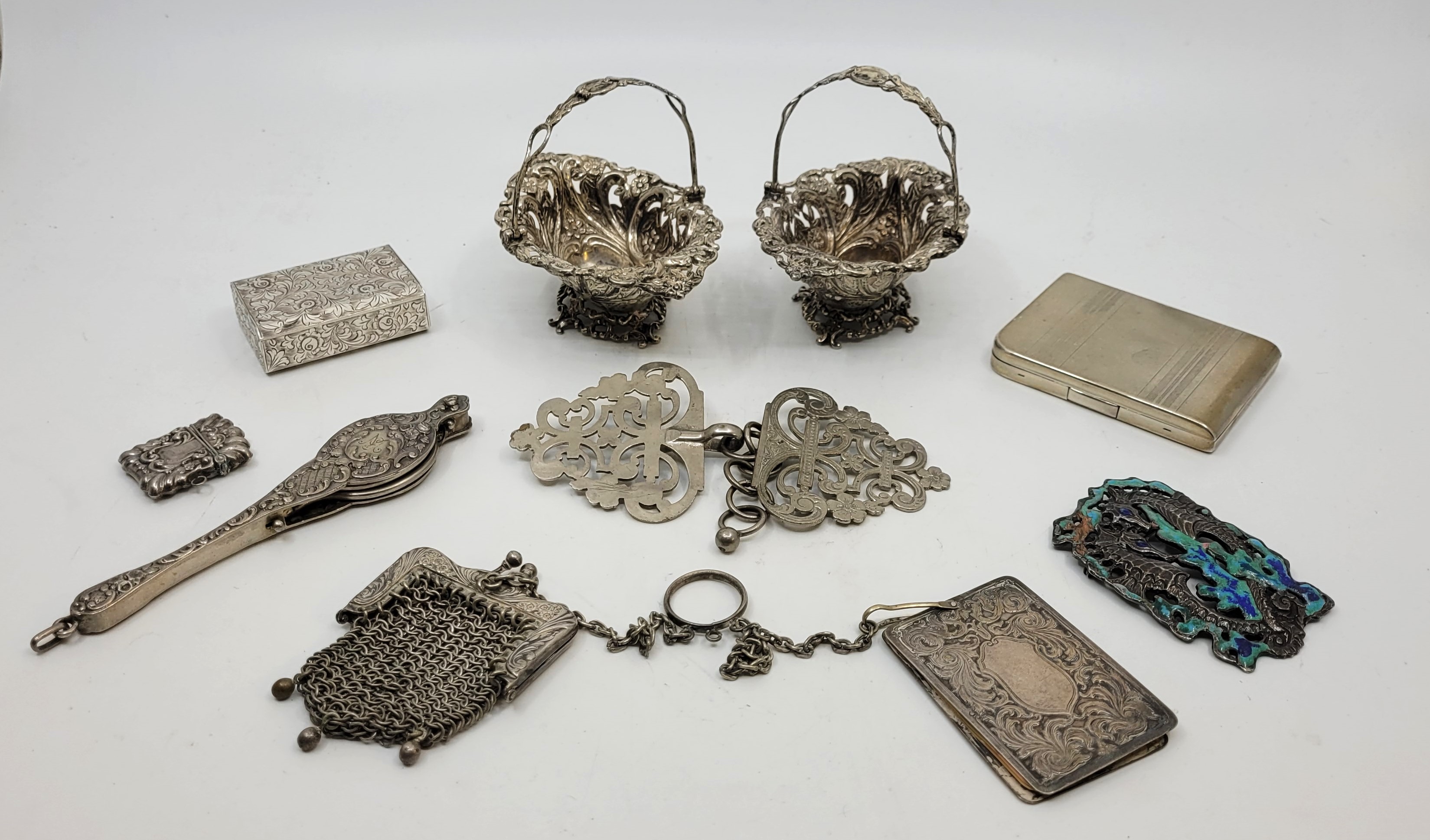 A pair of silver swing handled pierced bon bon baskets, by Joseph Hawkins (probably), Birmingham