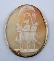 A 9ct. gold mounted oval shell cameo brooch, carved as "The Three Graces", height 59mm. (gross