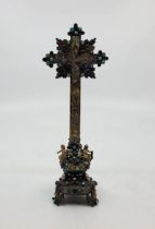 A 19th century Austro-Hungarian unmarked silver gilt, polychrome enamel and gem stone set cross, the