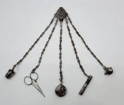 A 19th century cut steel chatelaine, the cut steel belt clip suspending sewing implements