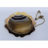 An 18ct. gold mounted agate brooch, set banded oval agate to centre, length 38mm. (gross weight 8.