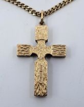 A 9ct. gold textured cross, height 36mm, suspended from a 9ct. gold curb link chain, length 72cm. (