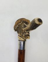 A humorous Victorian carved antler and silver mounted malacca walking stick, 1882, the handle formed