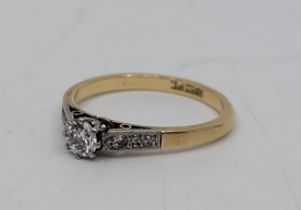An 18ct. gold and platinum diamond ring, claw set round brilliant cut diamond to centre (EDW 0.20