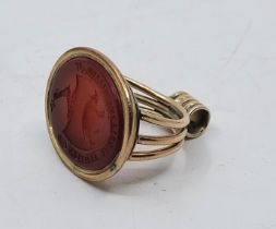 A large yellow metal and carnelian fob seal, the oval carnelian intaglio carved with wild boar to