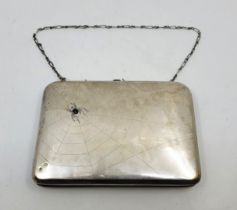 An early 20th century Russian silver purse, the front engraved with a spiders web, the spider set