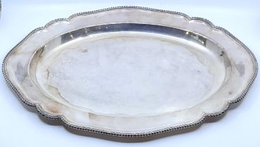 A silver oval meat dish by Asprey & Co. Ltd, London 1955, with gadrooned rim, length 52.2cm. (