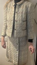 A vintage Chanel Couture wool two piece skirt suit, c.1960's, the jacket with four pockets and three