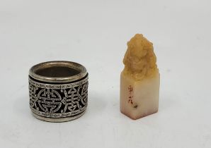 A Chinese white metal pierced swivel banded archers ring, impressed character marks to band