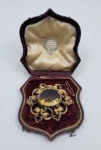 A large Victorian gilt metal openwork brooch set oval faceted citrine to centre, width 60mm, in