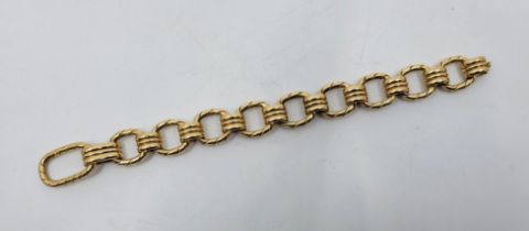 A heavy 14ct. gold fancy link bracelet, fashioned from cushion shape rope twist links alternating