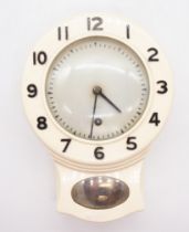 A 1930's Smiths 8 day, cream bakelite kitchen wall clock, having metal back and bakelite front,