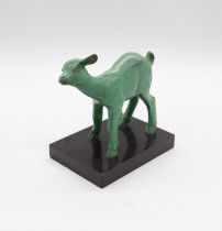 An Art Deco patinated green bronze fawn sculpture, on a rectangular black marble like stone base.