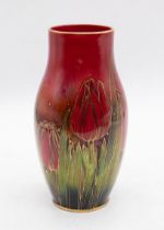 Harry Nixon for Royal Doulton - A Flambe vase of slender shouldered form, decorated with tulips,