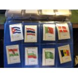 Cigarette card silks, approx 80. Flags, and regiments and medals. In an album. (S22)