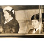 Queen Elizabeth II vintage press photograph with the now King Charles III in a car. Around 1960 (