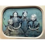 Photograph on glass of 4 young girls. Some hand colouring, mounted behind board.