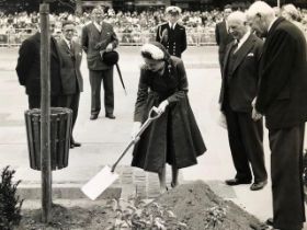 Queen Elizabeth vintage press photograph. Planting a tree at a public engagement. Press stamp on rev