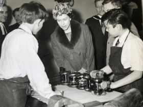 Queen Elizabeth vintage press photograph in a stylish hat, visiting a school, around the late 1960s.