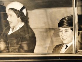 Queen Elizabeth II vintage press photograph with the now King Charles III in a car. Around 1960 (S22