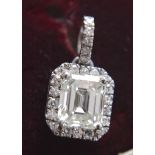 2.14CT DIAMOND EMERALD CUT DIAMOND PENDANT (WITH ROUND BRILLIANT CUT SIDE STONES) IN 14K WHITE GOLD