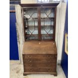 Georgian mahogany bureau bookcase with astragal glass, some panes cracked, and fitted interior.