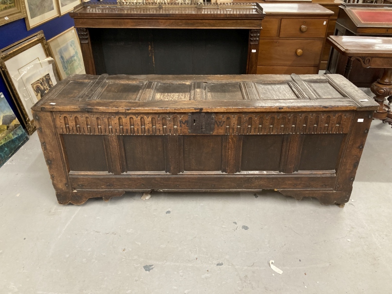 17th/18th cent. Oak and elm large coffer, the rectangular top with six panels carved frieze with