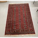 Carpets & Rugs: Late 19th/early 20th cent. Turkman rug, red ground with a central panel containing