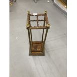 Late 19th cent. Brass and cast iron umbrella stand with four divisions and lift out tray. 24½ins.