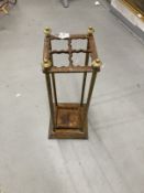 Late 19th cent. Brass and cast iron umbrella stand with four divisions and lift out tray. 24½ins.