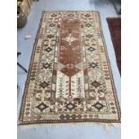 Carpets & Rugs: 19th cent. Kazak style carpet, ivory ground with a rose central panel. Five