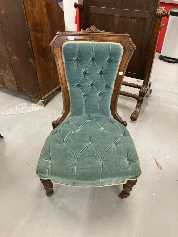 Aesthetic nursing chair with carved framework, upholstered back and seat on turned legs with brass