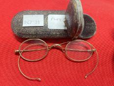 Late 19th/early 20th cent. Yellow metal rimmed spectacles, one in shagreen flip top case, the