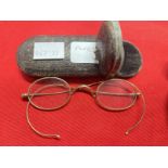 Late 19th/early 20th cent. Yellow metal rimmed spectacles, one in shagreen flip top case, the